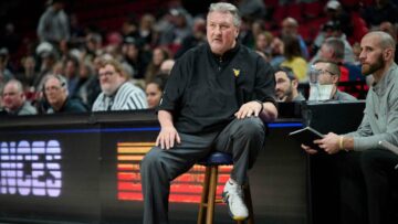 West Virginia suspends coach Bob Huggins, reduces salary $1 million